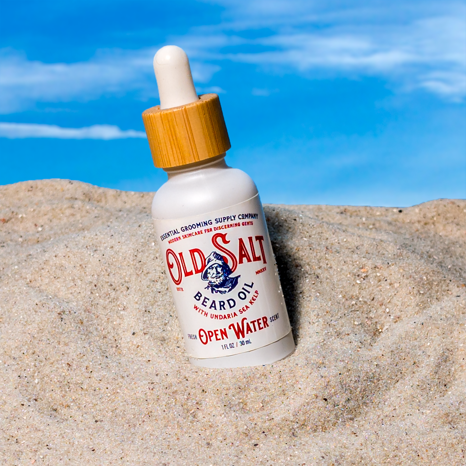 Bottle of Old Salt Beard Oil in Open Water Scent on a Sandy beach