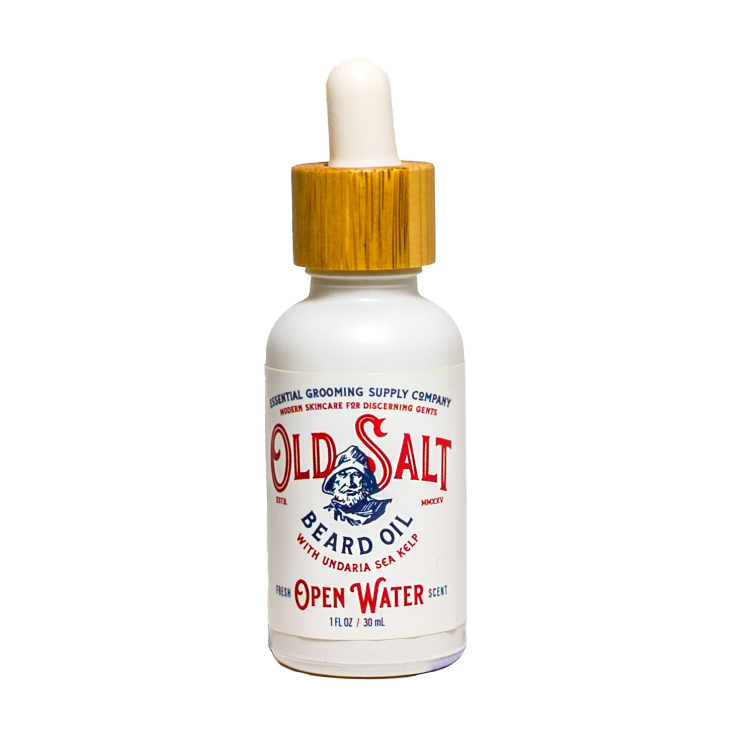 Bottle of Open Water 'Old Salt' beard Oil with sea kelp on white background