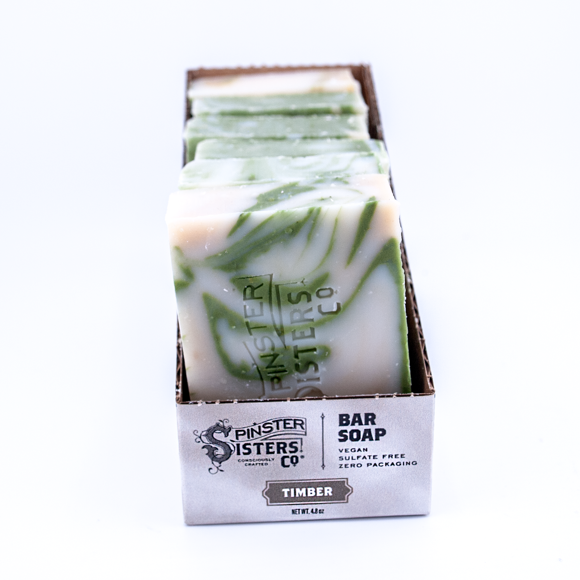 Case of Spinster Sisters Co. Timber bar soap with green and white swirls on a white background