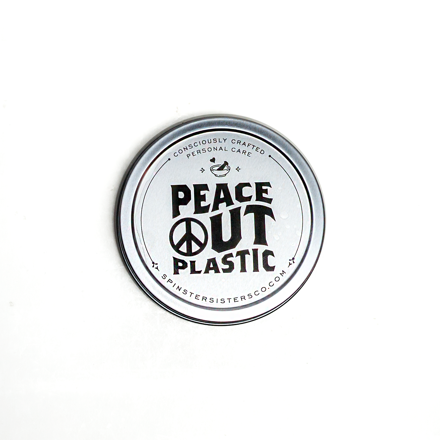 Round Silver Storage Tin with lid that reads 'Peace Out Plastic' text on a white background