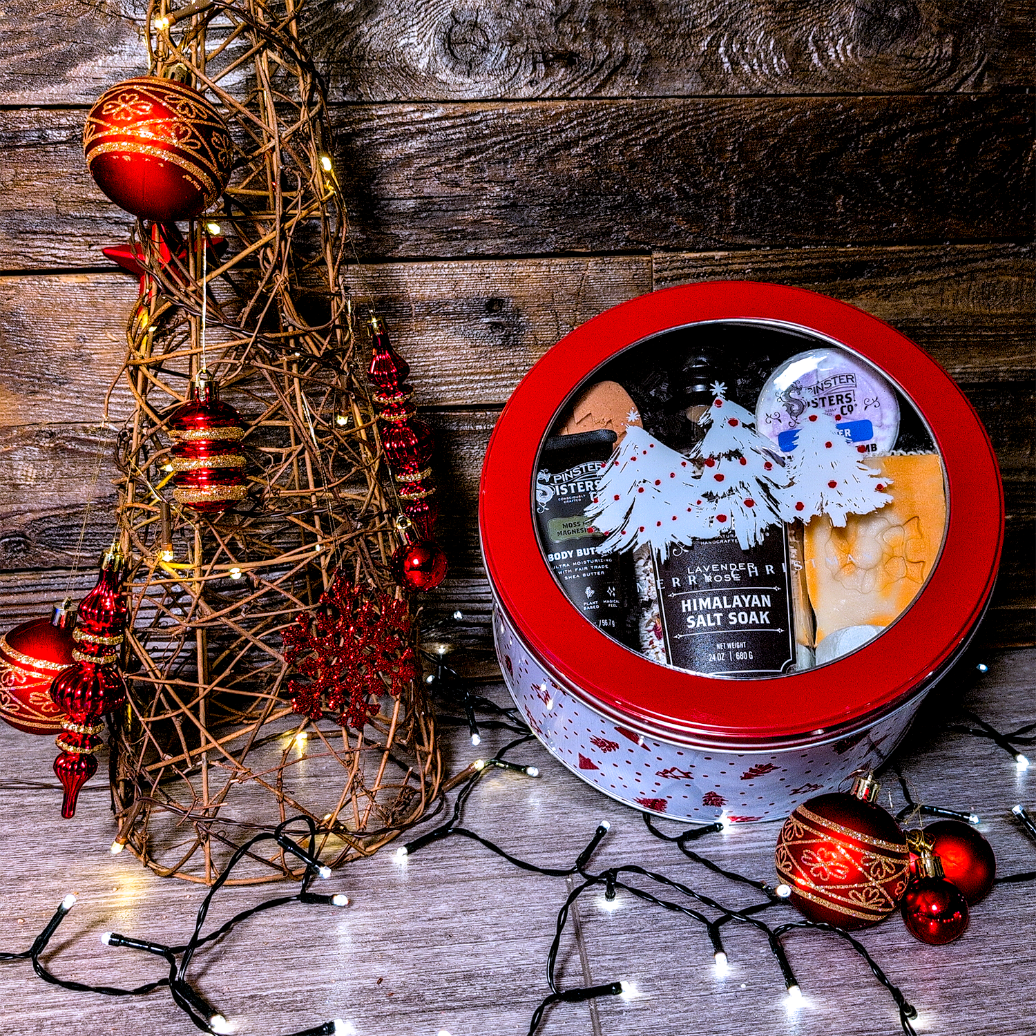 Decorative Christmas tree, Round Tin with Christmas design filled with Spinster Sisters Bath Products.