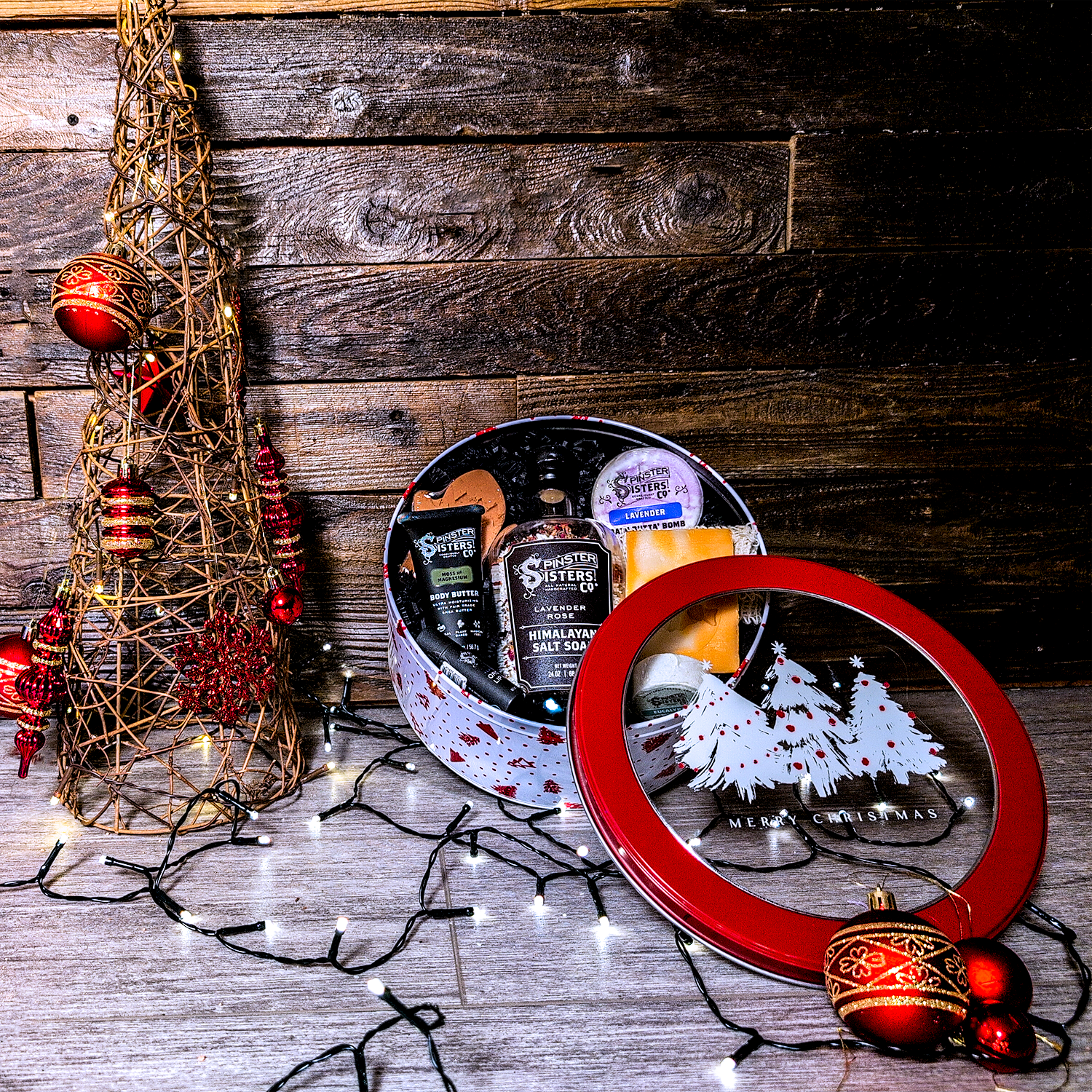 Decorative Christmas tree, Round Tin with Christmas design filled with Spinster Sisters Bath Products.