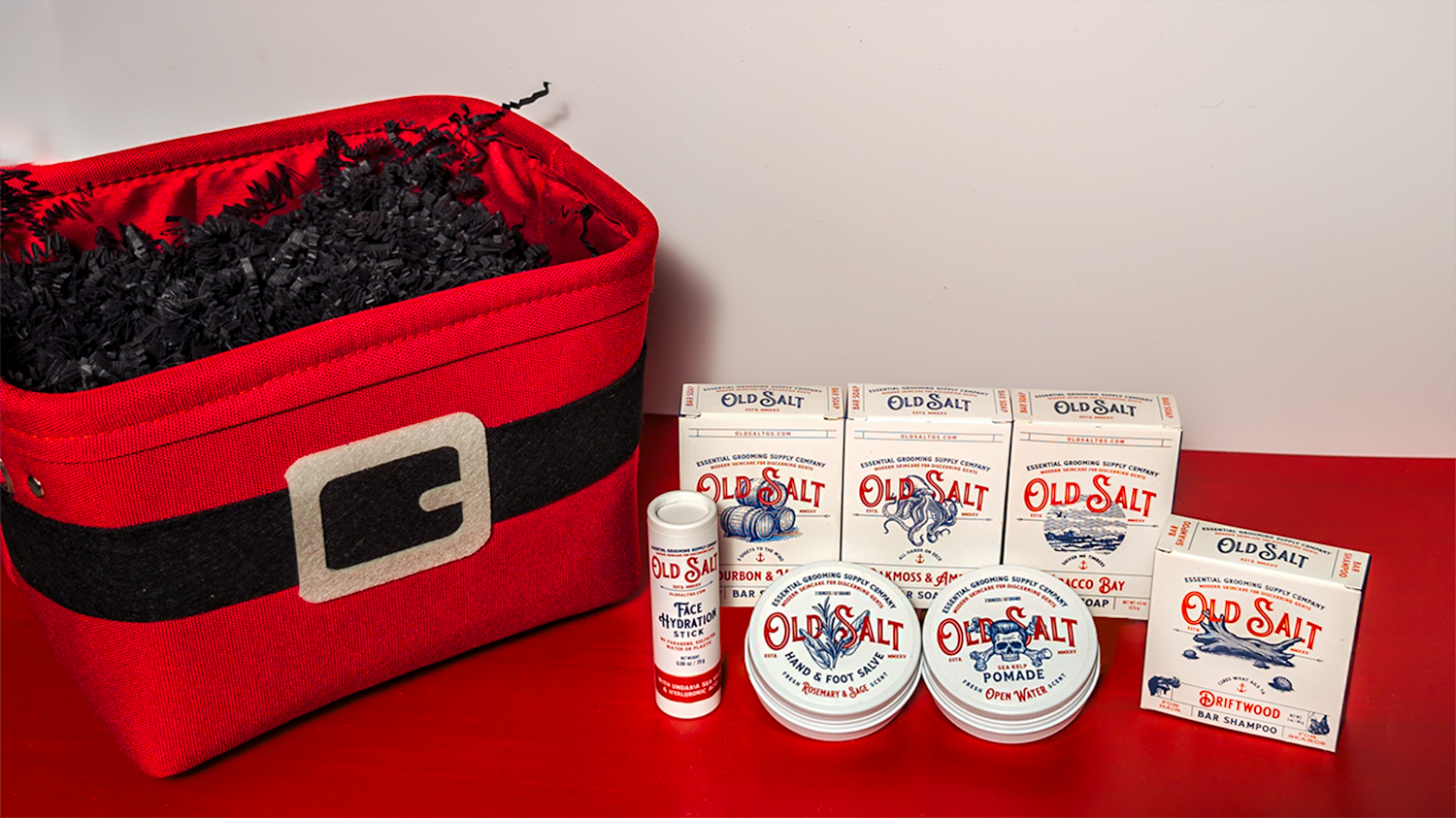 Santa Themed Gift Basket Featuringwith Old Salt product on a Red and White surface.