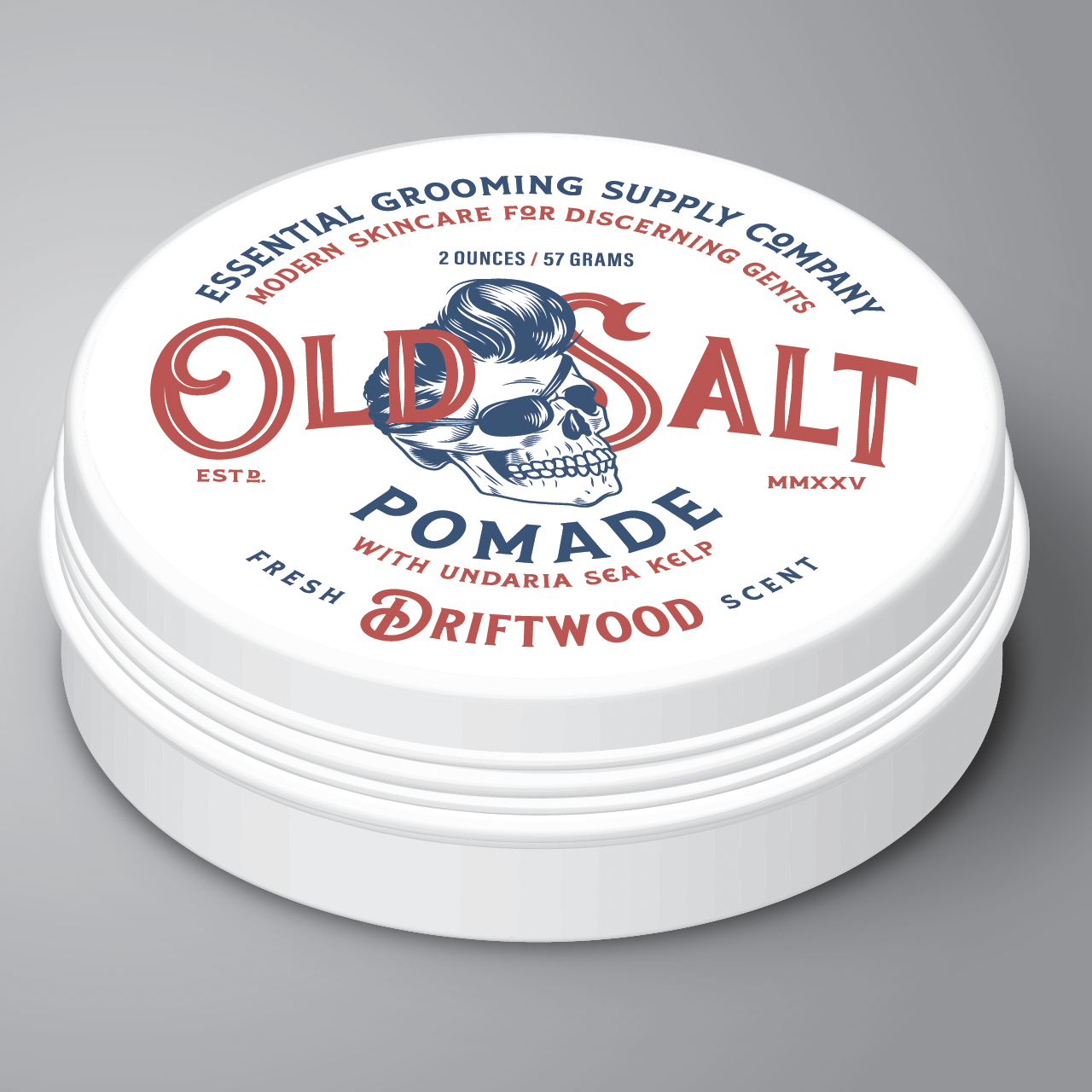 White tin Label reads " Essential Grooming Supply Company, Modern Skincare for discerning gents. Old Salt Pomade with undaria sea kelp, Scent Driftwood" an image of a skull with a pompadour and eye patch in the center