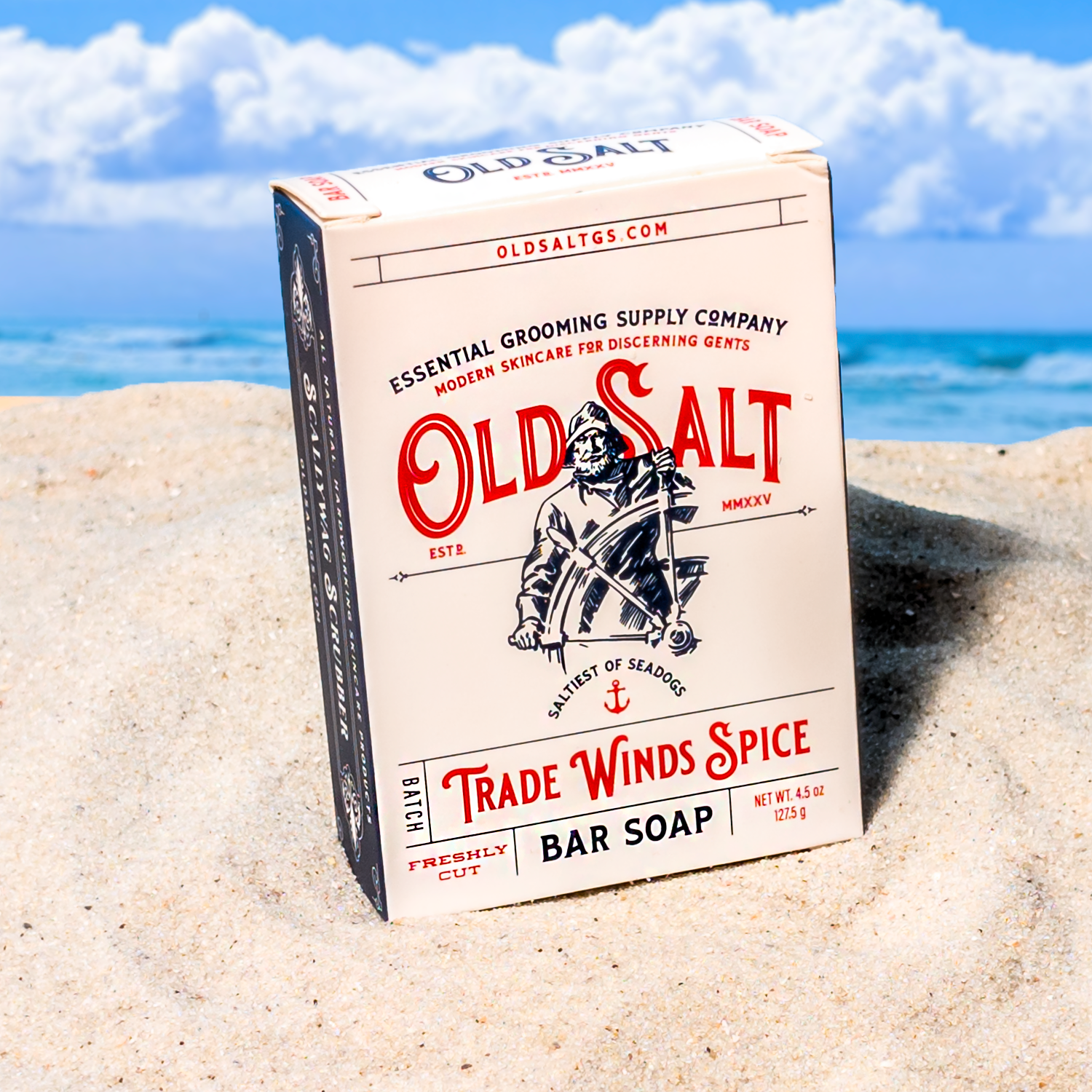 Box of Old Salt Trade Winds Spice on a Sandy beach