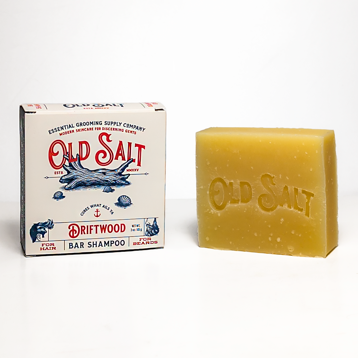 Bar of Old Salt Driftwood bar shampoo next to its packaging on a white background