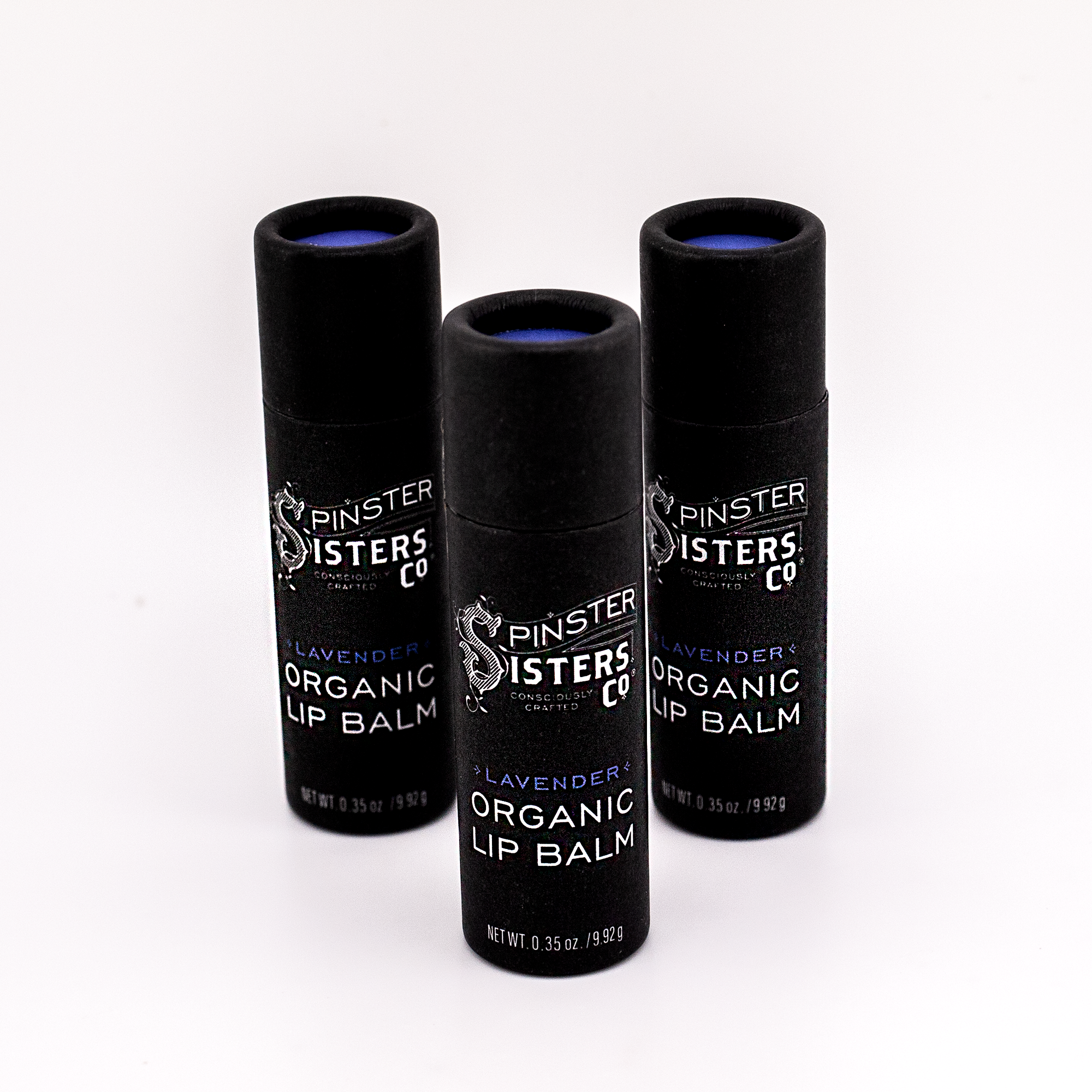 3 black paper tubes that say "Spinster Sisters Orange Organic Lip Balm" 