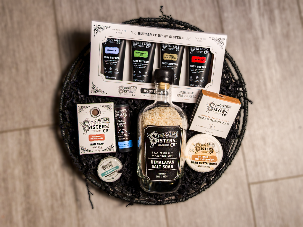 Collection of Spinster Sisters Co. Body Care products in a decorative basket.