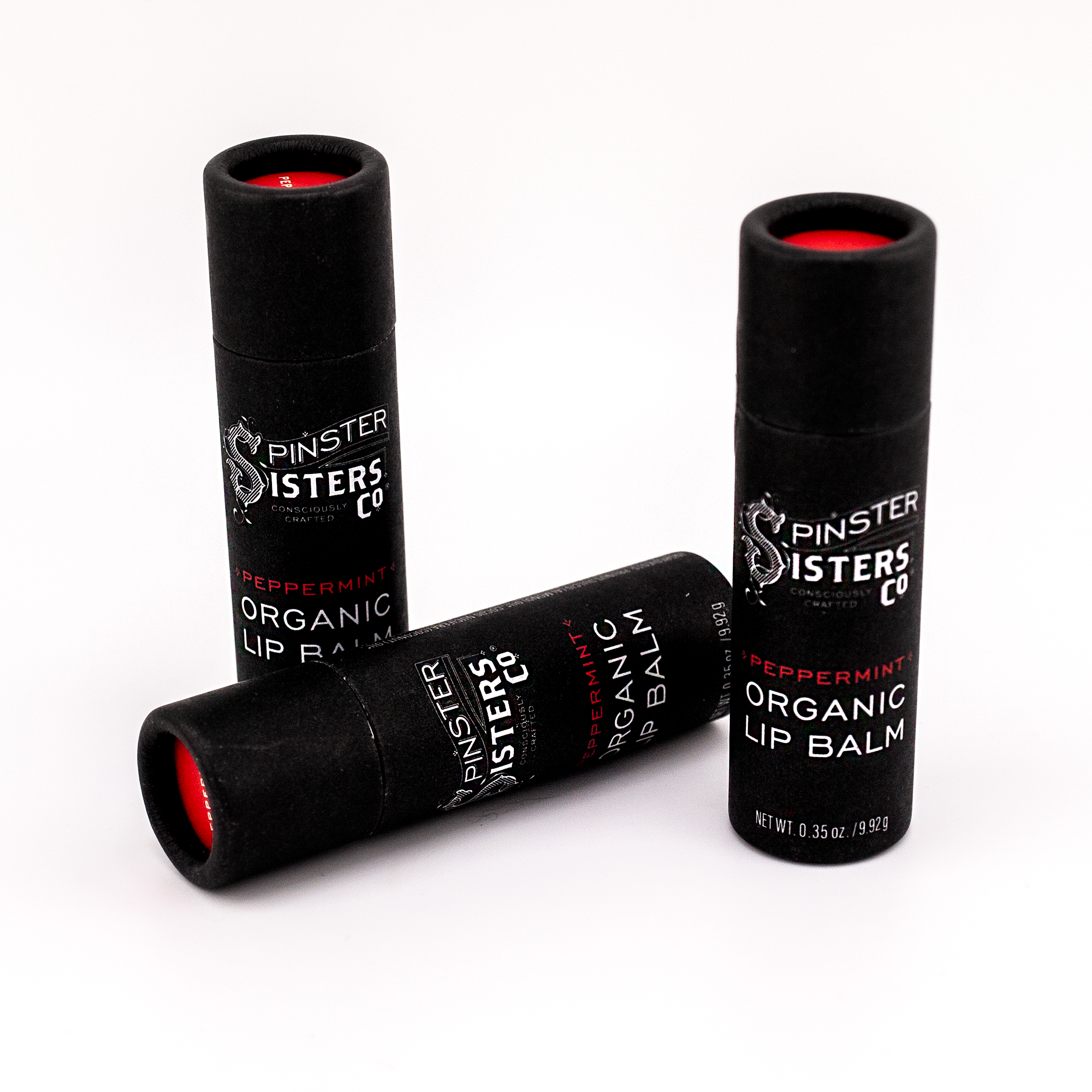 3 black paper tubes that say "Spinster Sisters Peppermint Organic Lip Balm" 