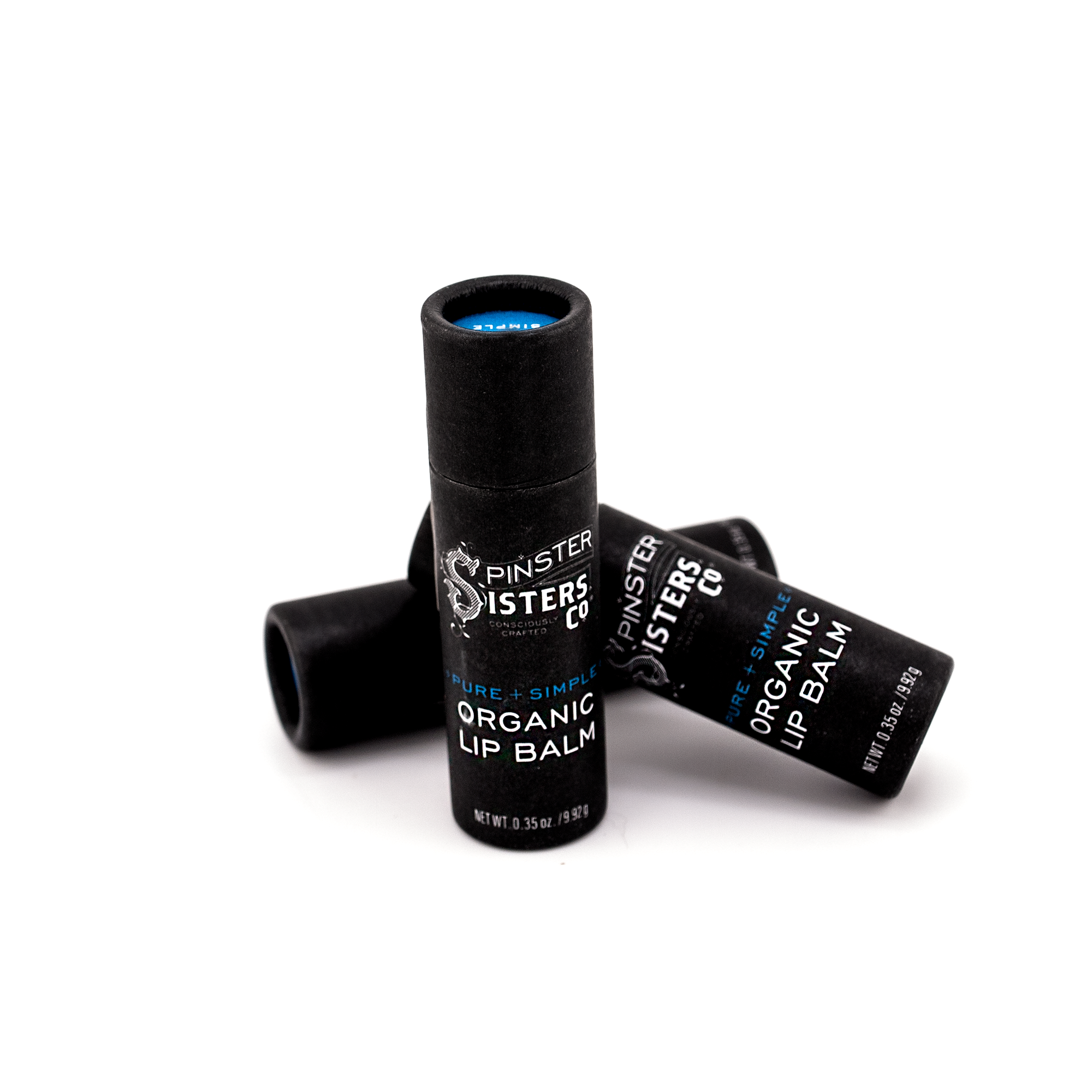 3 black paper tubes that say "Spinster Sisters Pure + Simple Organic Lip Balm" 