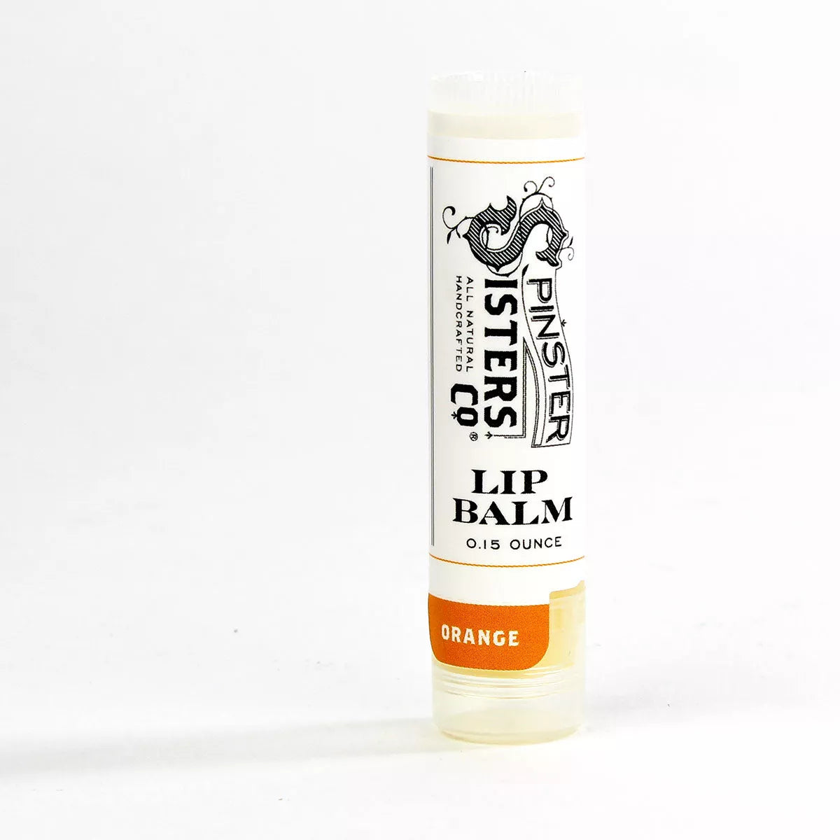 Clear tube of orange lip balm with beeswax